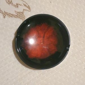 Homemade red and black ashtray